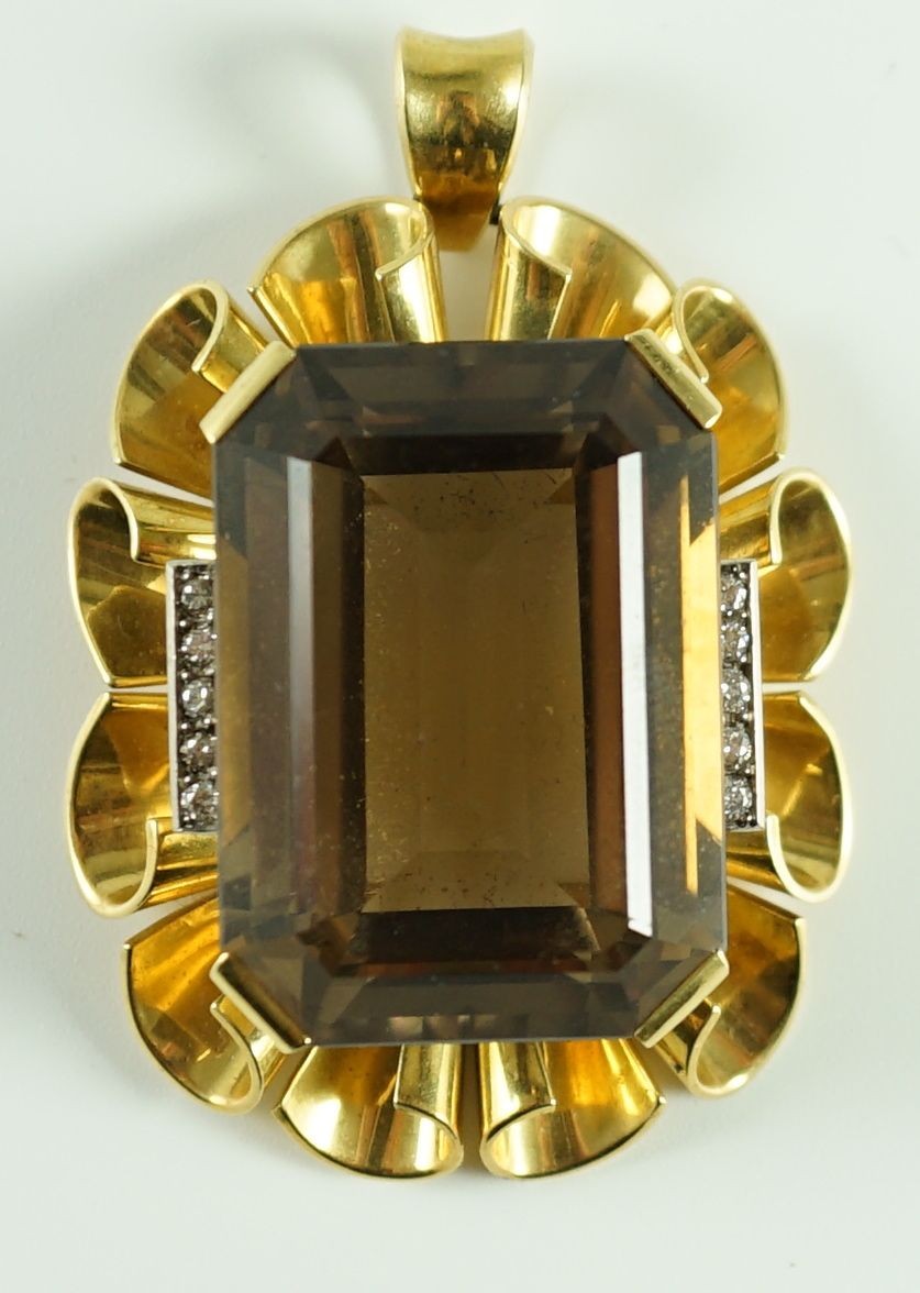 A modern 750 gold, emerald cut smoky quartz and diamond chip set oval pendant